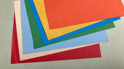 Abstract composition of colorful curved paper sheets. Designer paper in blue and pink. Empty space on monochrome paper. layered folds create a artistic and dynamic visual effect