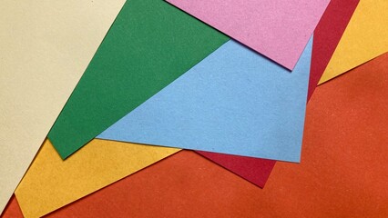layered paper sheets in various colors and shapes. Abstract composition of colorful curved paper sheets. Designer paper in blue and pink. Empty space on monochrome paper