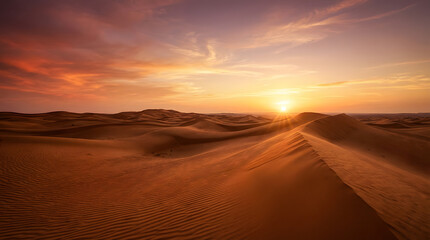 The image shows a desert landscape at sunset. The sun is setting over the sand dunes, painting the sky with warm colors.