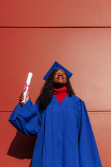 Young black woman smiling with closed eyes, feeling pride after completing her studies