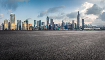 Empty asphalt road and modern city skyline with skyscrapers. © zhao dongfang