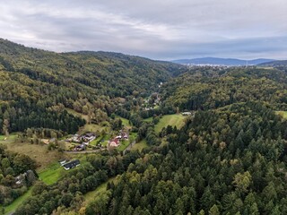 Obraz premium Serene Countryside Settlement With Gentle Hills, Remote Hamlet Surrounded By Lush Trees And Scenic Hillsides