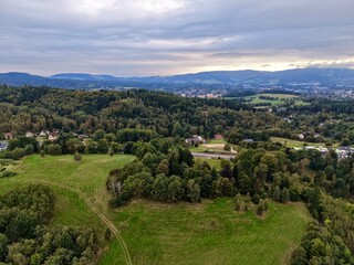 Obraz premium Serene Rural Areas Meet City Outskirts, Peaceful Farmlands Stretch Toward Distant City Skyline