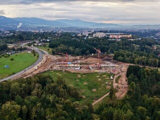 Obraz premium Building Site Near Green Surroundings, City Project Near Verdant Fields And Main Highway Pathways