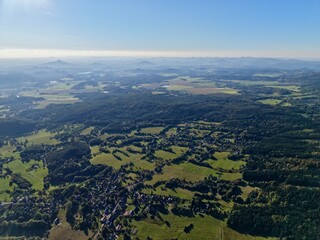 Fototapeta premium Highaltitude Rural Landscape, Aerial Perspective Showcasing Patchwork Fields And Rural Hamlets
