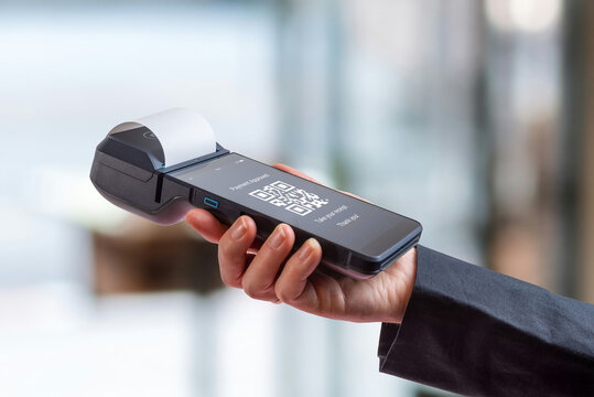 POS terminal displaying QR code payment interface, representing digital wallet transactions, mobile payments, and modern fintech solutions in retail environment - Powered by Adobe