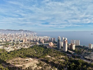 aerial perspective capturing urban expansion alongside protected natural areas and scenic mountains