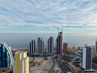 Naklejka premium elegant seaside buildings under development, luxury towers along peaceful shoreline being built