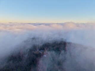 Fototapeta premium Misty Morning Over Village Landscape, Village Skyline Revealed Through Morning Fog And Gentle Light