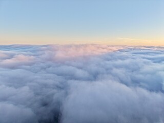 Calm Pastel Clouds Drift Over Sunrise Scene, Serene Morning Clouds Dance Beneath Glowing Sunrise Horizon © Nataliia