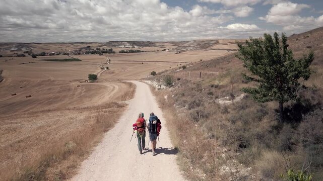 Two pilgrims walking through the Meseta sawanah in northern Spain