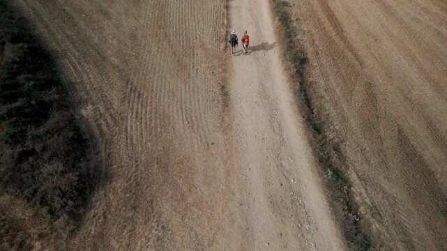 Two pilgrims walking through Meseta sawanah - French route to the Camino de Santiago