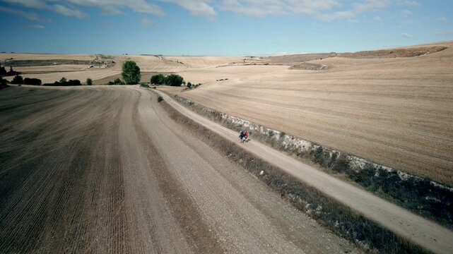Two pilgrims walking through Meseta sawanah - French route to the Camino de Santiago