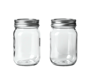 Two clear glass canning jars w/silver lids, black background