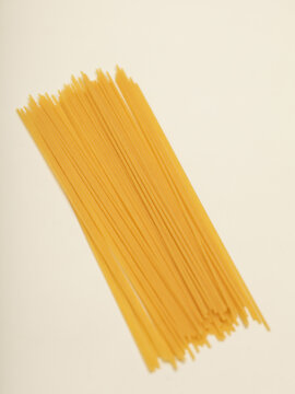 Raw spaghettis or pasta on white background