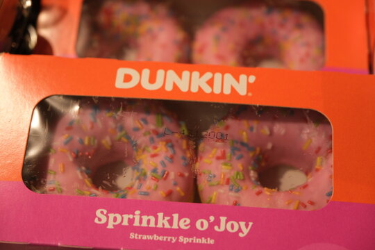 Brienz,Switzerland-Oct.1st 2025: Dunkin' brand strawberry sprinkle donuts inside a packaging box