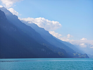 Obraz premium Iseltwald Alps mountain silhouette, turquoise water and mountain on Lake Brienz Switzerland