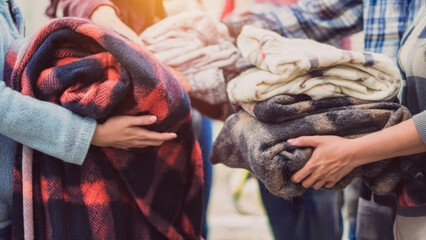 People Holding Warm Blankets