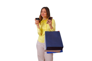 Woman holding shopping bags, credit card and smartphone, making online payment for e-commerce purchases