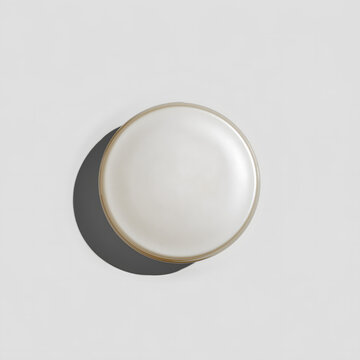 Blank round cosmetic jar lid or cream container cap with pearlescent finish and hard shadow perfect for beauty packaging mockup, cosmetic branding, and minimalist commercial advertising