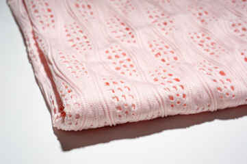 Close-up of patterned white fabric with holes