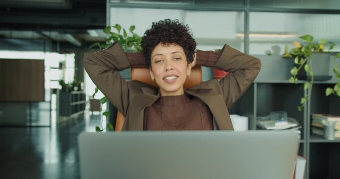 Confident business leader unwinds with contentment after discussion