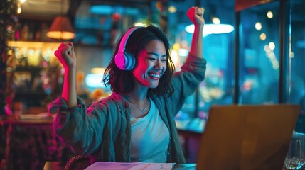Happy Young Woman Celebrating Online Success While Working on Laptop at Night