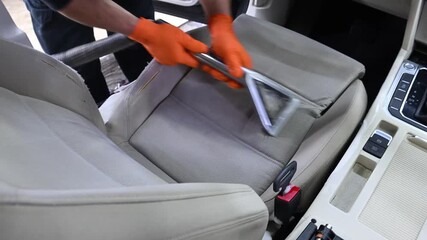 Professional car interior cleaning: Seat washing and detailed maintenance using a steam vacuum cleaner.