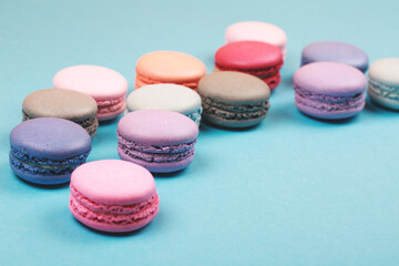 Obraz premium Group of pastel colorful macarons on trendy background.