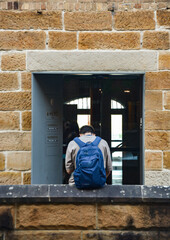 man sitting around the buildings on the Rocks, Sydney