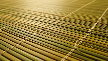 Close-up Perspective of Woven Bamboo Mat Texture with Natural Green and Yellow Bamboo Stalks