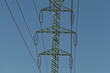 A tall telephone pole stands proudly against a bright blue sky, showcasing its essential role in...