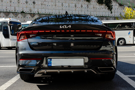 October 27, 2021, Seoul, South Korea - Rear view of a dark gray Kia K5 sedan parked on a city street.