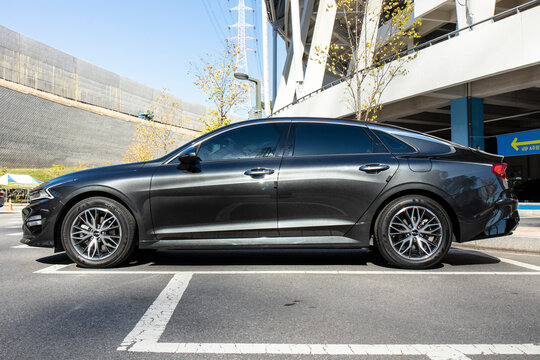 October 27, 2021, Seoul, South Korea - A dark gray Kia K5 sedan parked in an outdoor parking lot.
