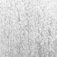 Fototapeta premium Frosted ice crystal texture on a white gray surface, abstract winter background