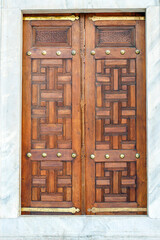 old wooden door in a marble wall, istanbul