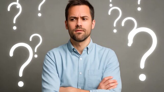 European male with thick beard, holds chin, pursed lips with clueless expressions, doubts, a man with many questions. 

