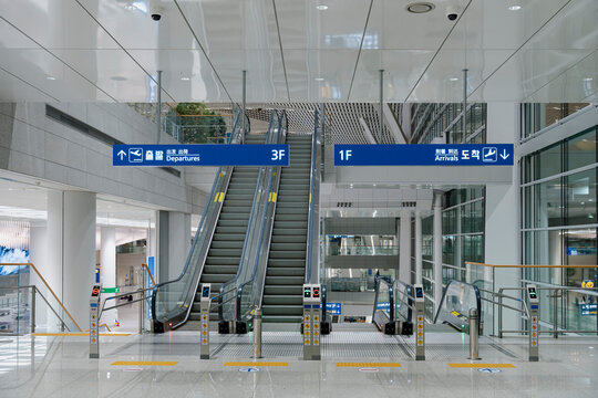 December 27, 2025, Incheon, South Korea - Directional signs for Departures and Arrivals above escalators at Incheon International Airport Terminal 2.