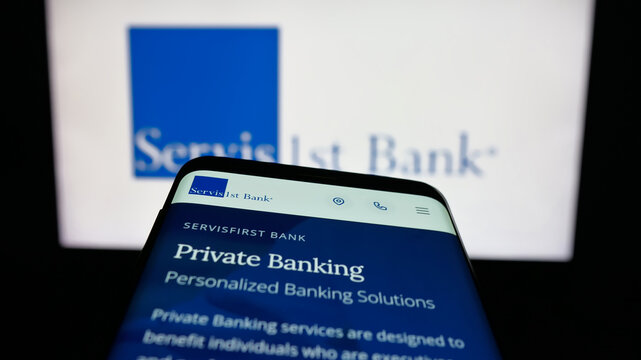 Stuttgart, Germany - 12-12-2025: Mobile phone with website of US bank ServisFirst Bancshares Inc. on screen in front of logo. Focus on top-left of phone display.