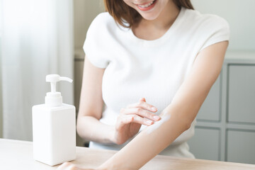 Health skin care, beauty smile asian young woman, girl  hand applying, putting moisturizer on her...