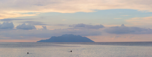 Serene Ocean View with Distant Island Silhouette at Twilight