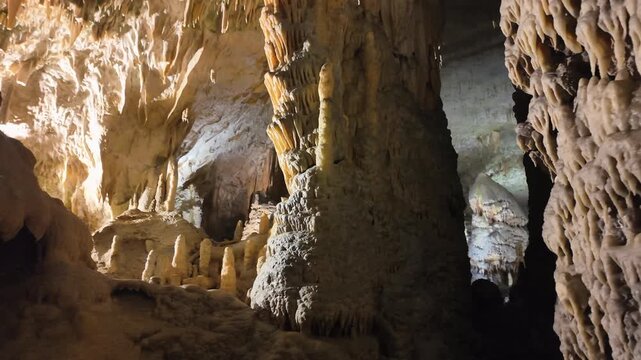 Majestic rock formations with stalactites and stalagmites inside a dark, underground cavern