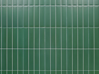 Green tile wall background with clean geometric pattern. Ceramic surface design suitable for interior, bathroom, kitchen, architecture, and decorative concepts.