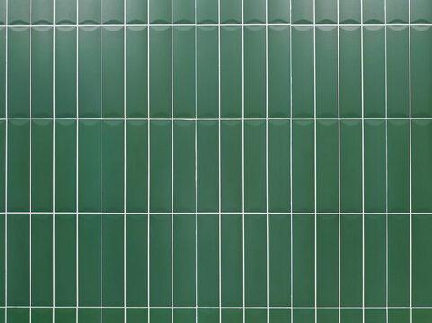Green tile wall background with clean geometric pattern. Ceramic surface design suitable for interior, bathroom, kitchen, architecture, and decorative concepts.