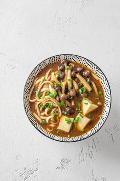 Japanese udon soup with Shimeji mushrooms, tofu, and rich dark umami broth