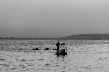 Fishermen on the sea, black and white