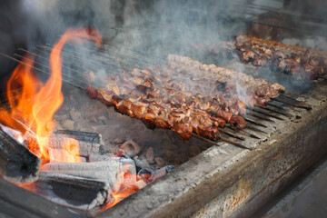 Grilled spiced ground beef and shish kebab over charcoal fire.