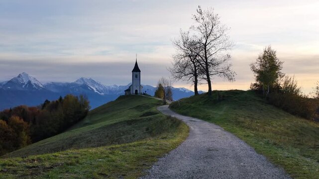 Picturesque sunrise at the iconic Saint Primus and Felician Church in Jamnik, Slovenia