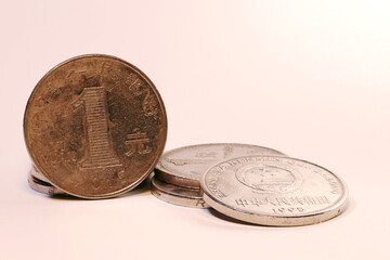 Chinese yuan coins on white background, close-up macro.
Close-up macro photograph of Chinese yuan coins arranged on a white background. Image shows different denominations of Chinese currency
