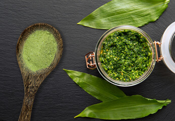Homemade pesto sauce and herbal salt made of Allium ursinum leaves, known as wild garlic, ramsons, buckrams, broad-leaved garlic, wood garlic, bear leek or bear's garlic.